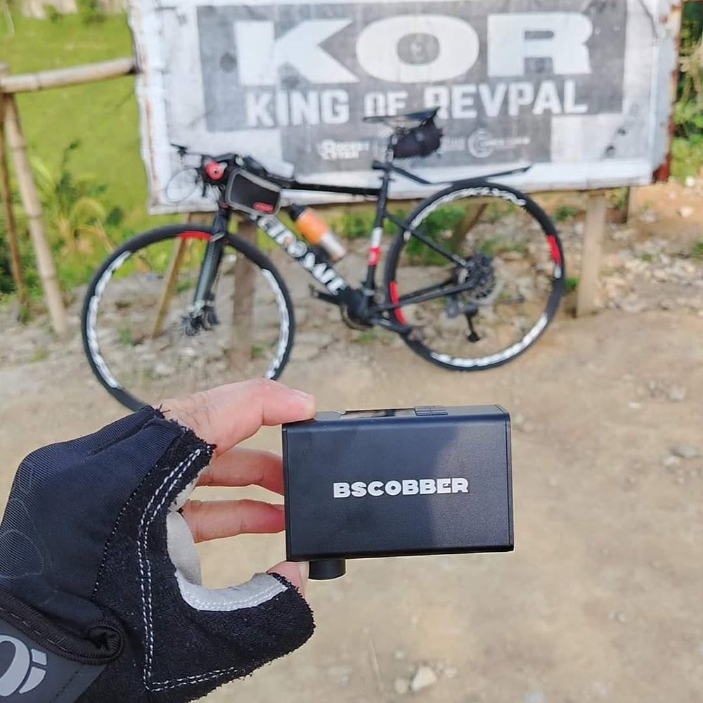 Influencer @calloanderson holding the BSCOBBER A3Max electric bike pump – compact, portable tire inflator for bikes, motorcycles, and outdoor gear