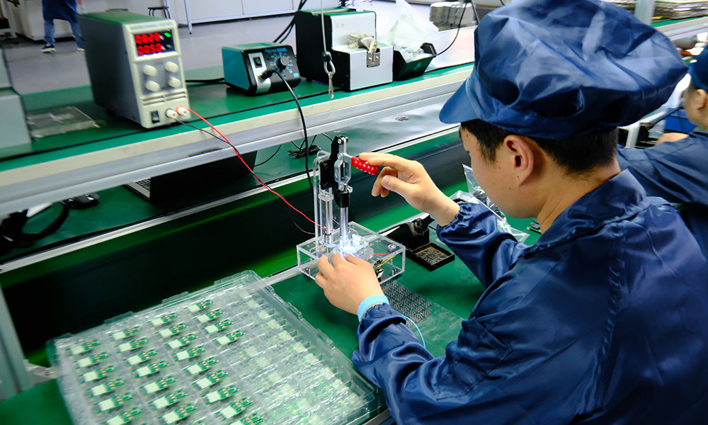 Technicians assembling electric bicycle pumps in BSCOBBER’s certified manufacturing facility.